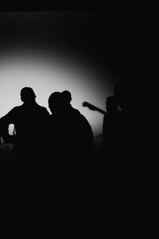 Silhouettes of people talking in a beam of light